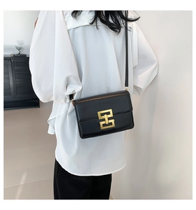 Close-up of elegant black PU leather crossbody bag featuring a classic gold square lock