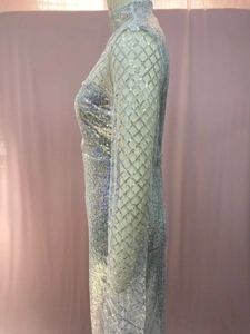 Detail of silver sequins and mesh sleeves on a slim-fit evening gown with rhombus pattern