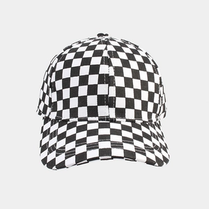 Close-up of black and white checkerboard canvas baseball cap with reinforced stitching