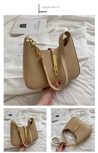 Detail view of apricot hobo bag with chunky gold chain strap and elegant metal buckle