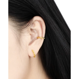 Minimalist gold geometric ear cuff and textured small hoop earrings set on female model