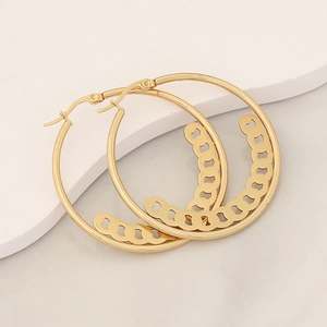Detailed view of large gold hoop earrings with hollow chain link texture on white background