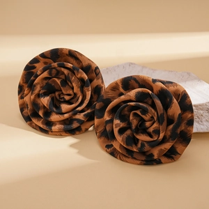 Close-up of retro leopard print fabric rose earrings with textured petal details