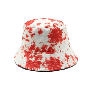 Detail shot of the red and white tie-dye pattern on the cotton bucket hat's fabric