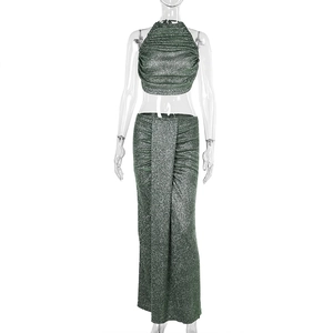 Close-up of forest green shimmering knit fabric with draped neckline and pleated detail