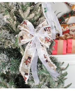 Detailed view of burlap Christmas tree bow with snowman print and Let it Snow text