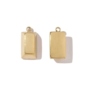 Detailed close-up of gold geometric textured rectangle steel pendants with ring attachment
