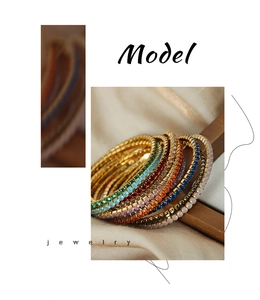 Detailed macro of colorful square-cut zircon inlay on gold-plated stretch bracelet