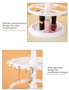 Detail view of white rotating jewelry organizer with tiered hooks and a divided base tray