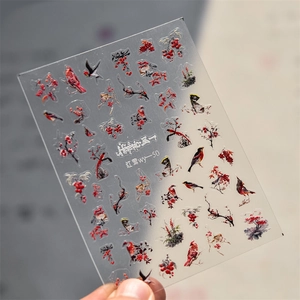 Detail of red berries and bird nail stickers on transparent film with realistic birds