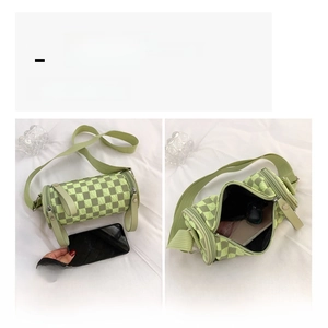 Detail of checkered cylinder bag showing interior capacity for phone and essentials
