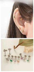 Detail shot of titanium labret studs with star, butterfly shapes and colorful zircons