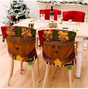 Detail of reindeer Christmas chair covers featuring festive elk motifs and plush fabric texture