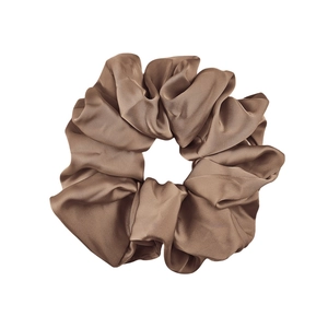 Detailed view of the soft brown satin scrunchie featuring rich folds and silk-like luster
