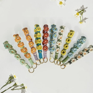 Handmade woven daisy flower keychains and phone straps in ten vibrant color options