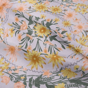 Close-up of floral tapestry fabric with yellow blossoms and green leaves on purple background