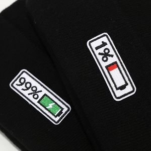 Unisex black knitted beanie featuring creative 1% and 99% battery embroidery design