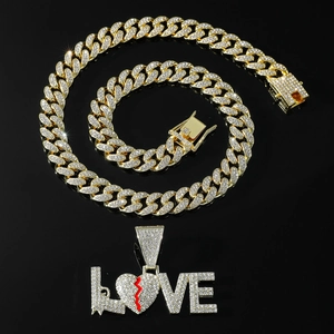 Hip hop style gold Cuban chain necklace with iced out LOVE pendant featuring a broken heart