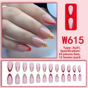 Detail of almond-shaped nude press-on nails with red French tips and gold foil accents