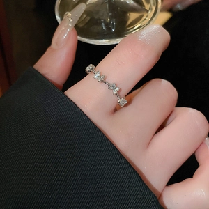 Detail of silver butterfly ring with faux pearls on model's hand for luxury style