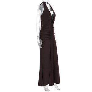Detail of ruched texture and open back on a chocolate brown halter neck maxi dress