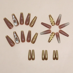 Long ballerina press-on nails with brown color, gold snake charm and rhinestone gems