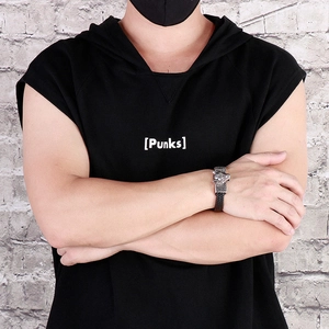 Detail of wolf head buckle and black braided leather bracelet on male model wrist