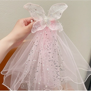 Detail of pink bow hair clip with layered tulle veil, silver sequins and white beads