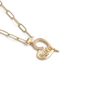 Close-up of gold MOM heart pendant with cubic zirconia on a trendy paperclip chain