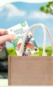 Portable insect watercolor painting book set being placed in a natural linen tote bag