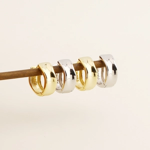 Macro view of S925 sterling silver hoop earrings in polished gold and silver finishes