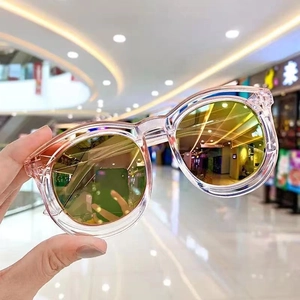 Kids trendy oversized sunglasses with transparent pink frames and golden mirror lenses