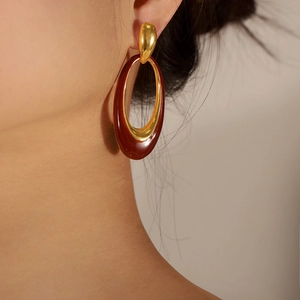 French vintage style oval enamel drop earrings in red and gold finish on model