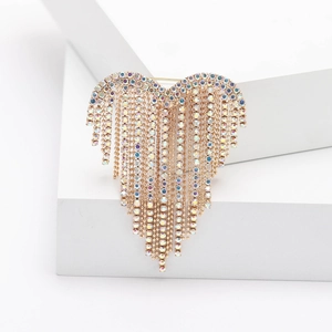 Elegant gold heart brooch with colorful crystal tassels and rhinestones on a white stand