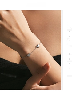 Detail of 925 sterling silver heart bracelet featuring pavé crystals and polished finish