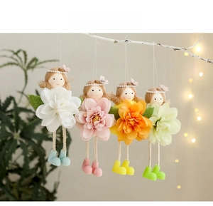 Set of four handmade Easter flower girl ornaments hanging on branches for festive party decor