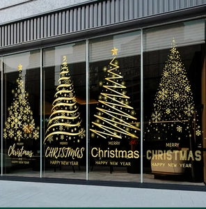 Macro view of four golden Christmas tree window stickers with Merry Christmas text decoration