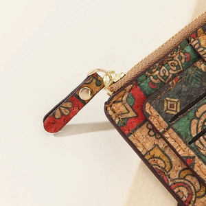 Close-up of cork wallet featuring colorful ethnic patterns and premium metal zipper detail
