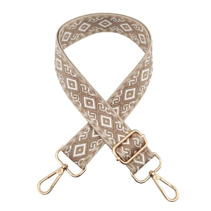 Detail of khaki and white geometric jacquard bag strap with golden metal buckles
