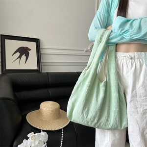 Detail showing the pleated bubble texture on a mint green large capacity tote bag