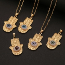 Detail of Hamsa Hand pendants with colorful Evil Eye stones on thin gold link chains