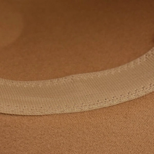 Close-up of the interior sweatband and fine stitching on a camel wool felt fedora hat