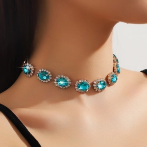 Detailed view of large teal oval crystals surrounded by small white diamonds on a gold choker