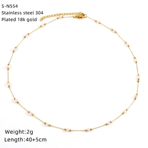 Detail of pink crystal necklace in 18K gold plated stainless steel on white background