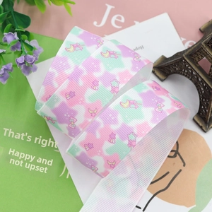Detail of colorful grosgrain ribbon with moon and star patterns for DIY hair accessories