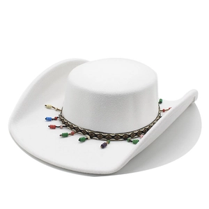 Detail of white felt cowboy hat featuring colorful beads and ethnic woven decorative band