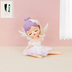 Detail of a ballet dancer figurine with purple hair and white wings on a pink background