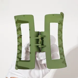 Detailed macro view of matte military green hair claw clip with large rectangular frame
