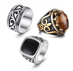 Detailed view of three vintage steel rings with tiger eye stone and black enamel inlay