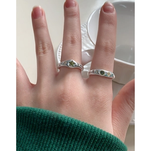 S925 silver geometric ring with green star zircon worn on hand for casual luxury
